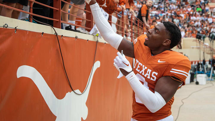 April 20, 2024; Austin, Texas, USA: Texas Orange team defensive back Terrance Brooks (8) signs autographs for fans while visiting for the Longhorns' spring Orange and White game at Darrell K Royal Texas Memorial Stadium. Mandatory Credit: Sara Diggins-Imagn Images via American Statesman