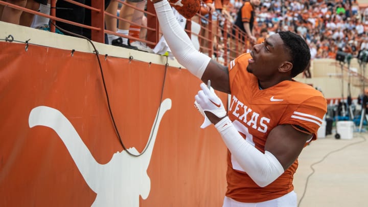 April 20, 2024; Austin, Texas, USA: Texas Orange team defensive back Terrance Brooks (8) signs autographs for fans while visiting for the Longhorns' spring Orange and White game at Darrell K Royal Texas Memorial Stadium. Mandatory Credit: Sara Diggins-USA Today Sports via American Statesman