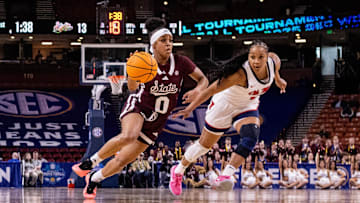 Mar 6, 2025; Greenville, SC, USA; Mississippi State Bulldogs guard Denim DeShields (0) drives by Ole Miss Rebels guard KK Deans (1) during the first half at Bon Secours Wellness Arena. Mandatory Credit: Scott Kinser-Imagn Images