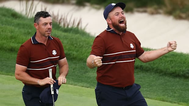 Rory McIlroy and Shane Lowry of Team Europe celebrate after winning Saturday afternoon at the Ryder Cup.