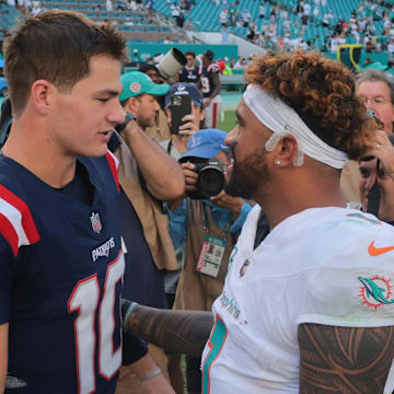 Nov 24, 2024; Miami Gardens, Florida, USA; New England Patriots quarterback Drake Maye (10) and Miami Dolphins quarterback Tua Tagovailoa (1) talk on the field after the game at Hard Rock Stadium. Mandatory Credit: Sam Navarro-Imagn Images