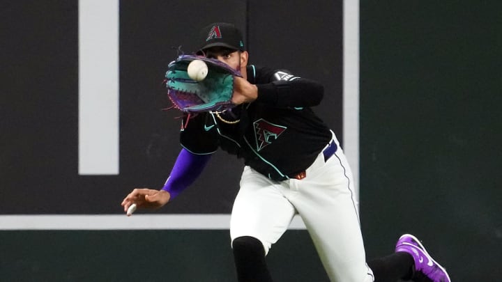 Aug 8, 2024; Phoenix, Arizona, USA; Arizona Diamondbacks outfielder Lourdes Gurriel Jr. (12) makes a catch against the Philadelphia Phillies during the third inning at Chase Field. Mandatory Credit: Joe Camporeale-USA TODAY Sports