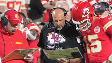 Oct 7, 2024; Kansas City, Missouri, USA; Kansas City Chiefs quarterback Patrick Mahomes (15) looks at plays with offensive coordinator Matt Nagy, center, and head coach Andy Reid against the New Orleans Saints during the first half at GEHA Field at Arrowhead Stadium.