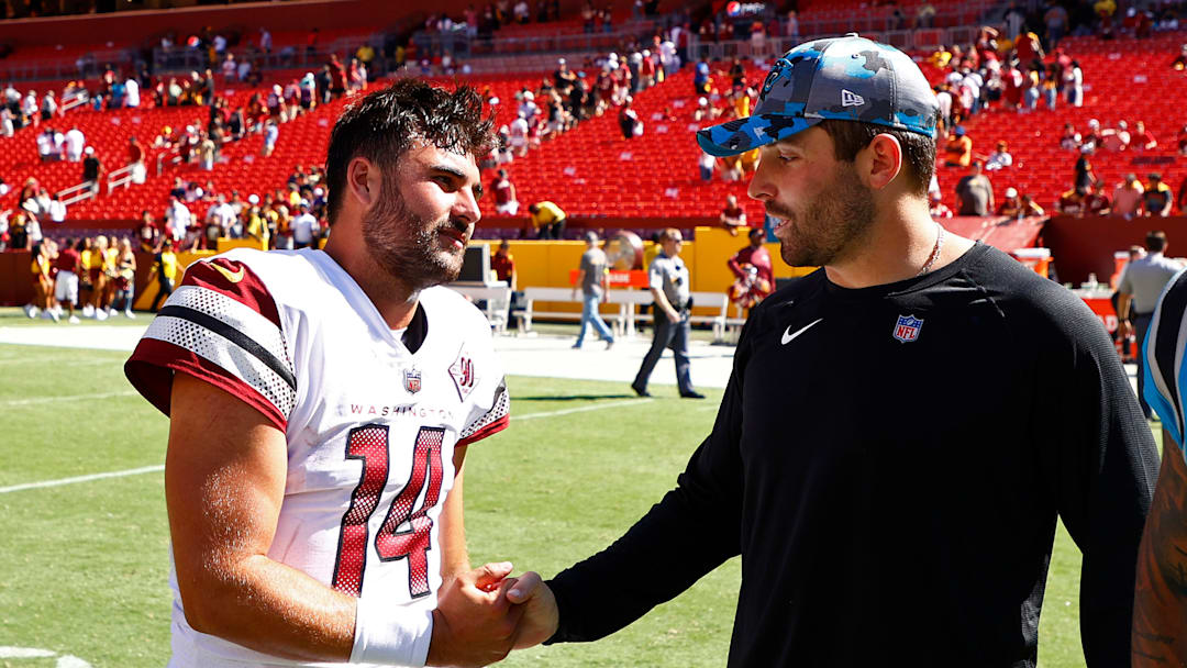 Aug 13, 2022; Landover, Maryland, USA; Washington Commanders quarterback Sam Howell (14) shakes hands with Carolina Panthers quarterback Baker Mayfield (R) after their game at FedExField.