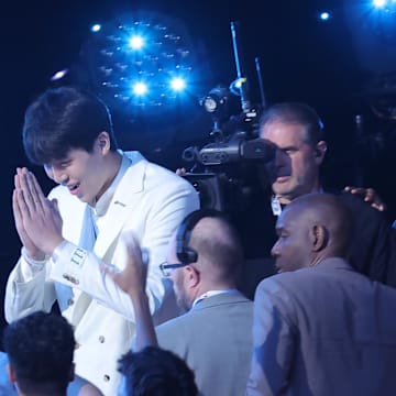 Jun 25, 2025; Brooklyn, NY, USA;  Yang Hansen walks to the stage after being selected as the 16th pick by the Memphis Grizzlies in the first round of the 2025 NBA Draft at Barclays Center. Mandatory Credit: Brad Penner-Imagn Images