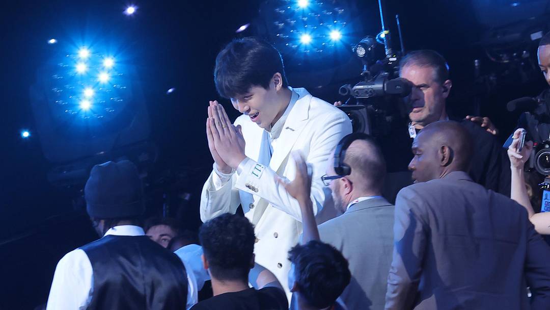 Jun 25, 2025; Brooklyn, NY, USA;  Yang Hansen walks to the stage after being selected as the 16th pick by the Memphis Grizzlies in the first round of the 2025 NBA Draft at Barclays Center. Mandatory Credit: Brad Penner-Imagn Images