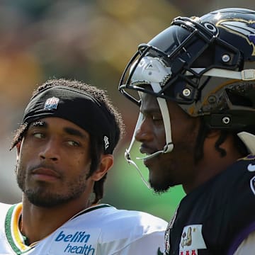 Green Bay Packers cornerback Jaire Alexander talks with Baltimore Ravens quarterback Lamar Jackson during a joint practice.