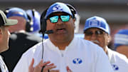 Nov 8, 2025; Lubbock, Texas, USA;  Brigham Young Cougars head coach Kalani Sitake discusses a call with Big 12 official Randy Smith in the second half of the game against the Texas Tech Red Raiders at Jones AT&T Stadium. 