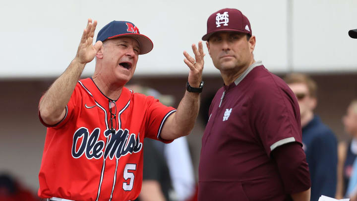 Ole Miss Rebels Head Coach Mike Bianco interacts with Mississippi State Bulldogs Head Coach Chris Lemonis.