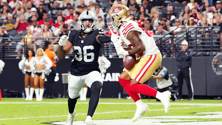 Aug 23, 2024; Paradise, Nevada, USA; San Francisco 49ers wide receiver Jacob Cowing (83) makes a touchdown catch against Las Vegas Raiders cornerback Rayshad Williams (36) during the third quarter at Allegiant Stadium. Mandatory Credit: Stephen R. Sylvanie-Imagn Images