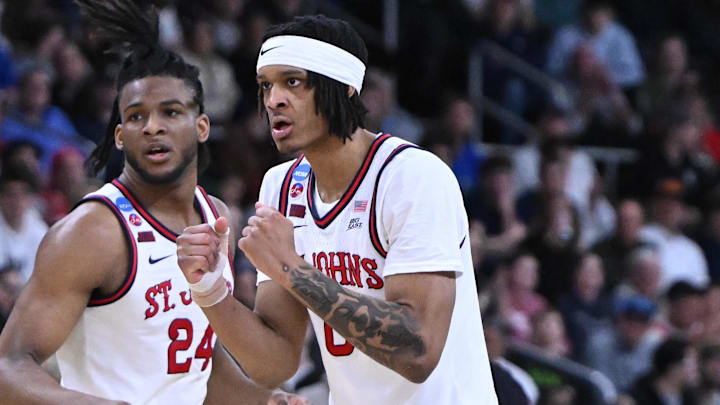Aaron Scott #0 of the St. John's Red Storm reacts to a play in front of forward Zuby Ejiofor (24) during the second-round men’s NCAA Tournament game against the Arkansas Razorbacks.