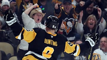 Dec 7, 2024; Pittsburgh, Pennsylvania, USA;  Pittsburgh Penguins left wing Michael Bunting (8) reacts to the crowd after scoring a goal against the Toronto Maple Leafs during the third period at PPG Paints Arena. Mandatory Credit: Charles LeClaire-Imagn Images