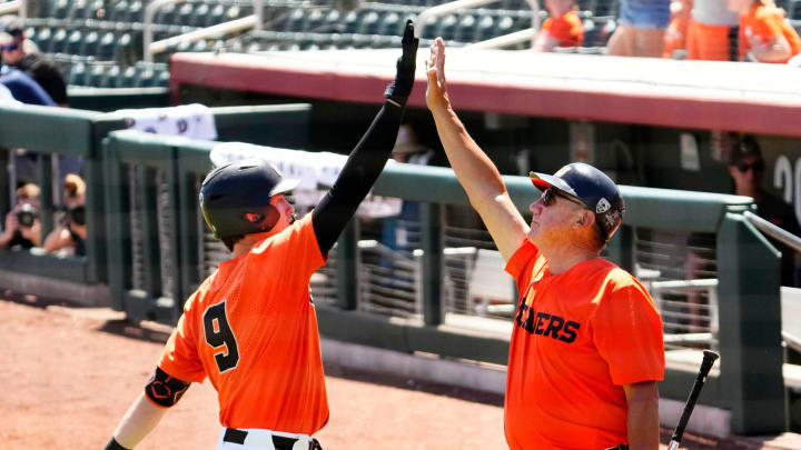 Mason Guerra of Oregon State (left) celebrates after hitting a solo home run against Arizona State in the second inning during the Pac-12 Tournament at Scottsdale Stadium on May 25, 2023.