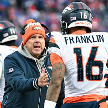 Jan 12, 2025; Orchard Park, New York, USA; Denver Broncos head coach Sean Payton has a word with wide receiver Troy Franklin (16) in the fourth quarter of an AFC wild card game against the Buffalo Bills at Highmark Stadium. 
