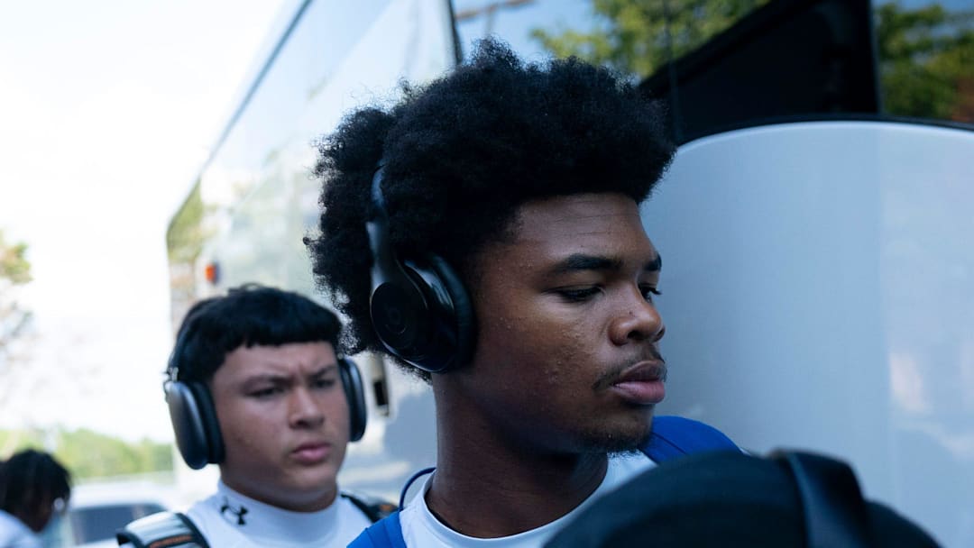 Antioch quarterback Andre Adams, center, boards the bus with his teammates at Antioch High School in Antioch, Tenn., Friday, Aug. 22, 2025. The Bears were on their way to Mt. Juliet High School to open their season against the Golden Bears.