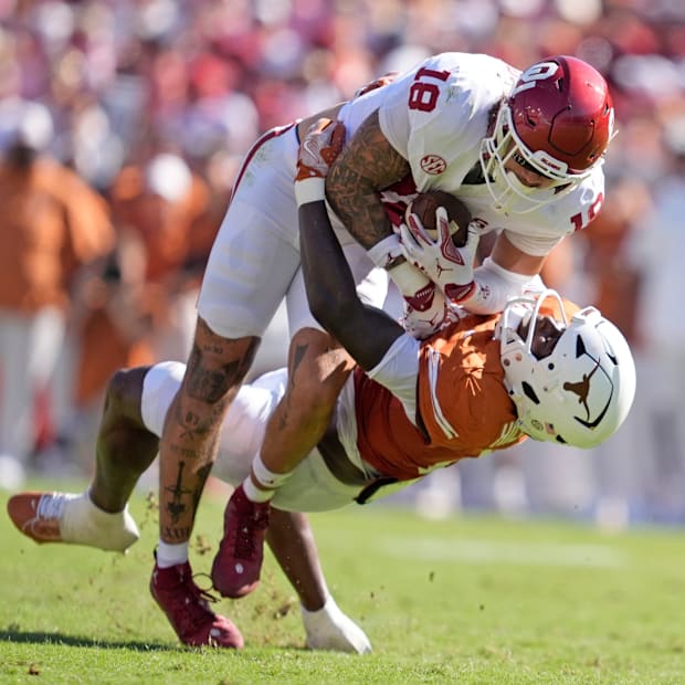 Oklahoma Sooners tight end Kaden Helms (18) looks to get by Texas Longhorns defensive back Jelani McDonald (4).