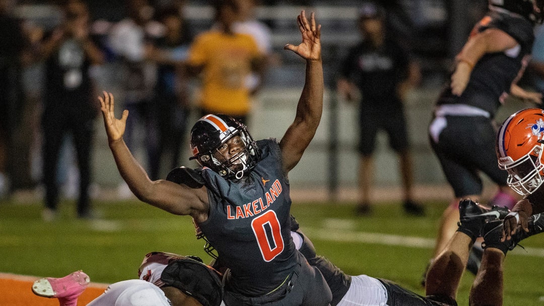 Lakeland (0) Malik Morris signals a Lakeland touchdown in a 2023 contest against Bartow.