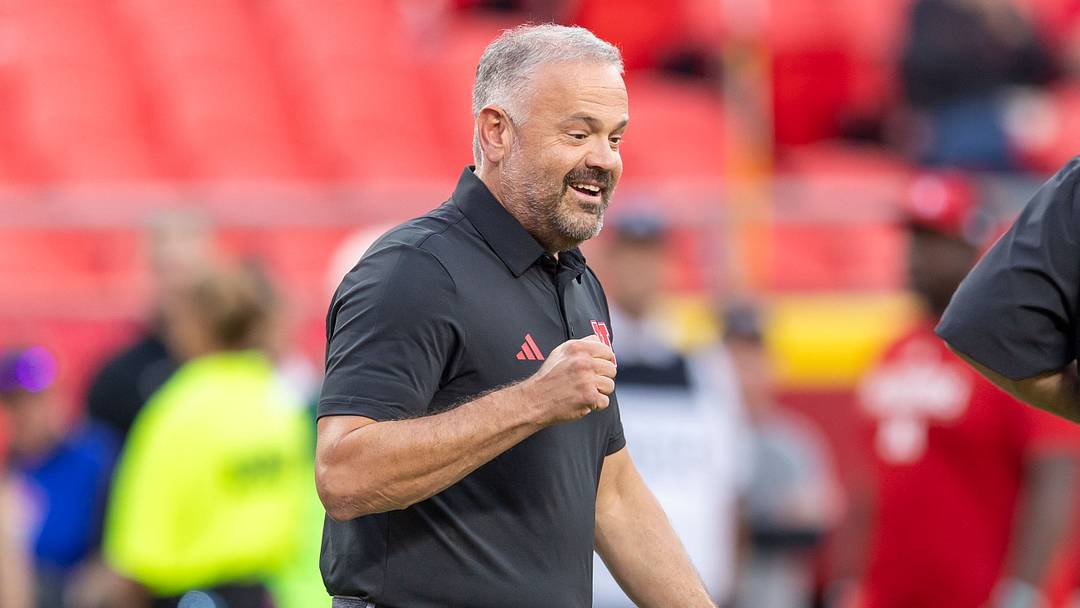 Matt Rhule walks onto the field before the 2025 season opener against Cincinnati. 