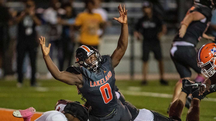 Lakeland (0) Malik Morris signals a Lakeland touchdown in a 2023 contest against Bartow.