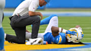 Sep 21, 2025; Inglewood, California, USA;   Los Angeles Chargers medical staff check on running back Najee Harris (22) after an injury in the first half against the Denver Broncos at SoFi Stadium. Mandatory Credit: Jayne Kamin-Oncea-Imagn Images