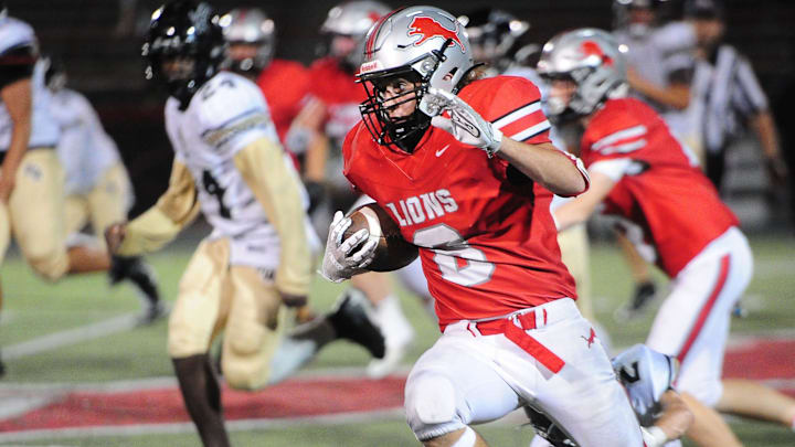 Minerva's Jayden Yerger runs a sweep against St. Thomas Aquinas, Friday, Sept. 20, 2024. The Lions won 16-7 to end a 33-game losing streak, while extended Aquinas' losing skid to 31 games.