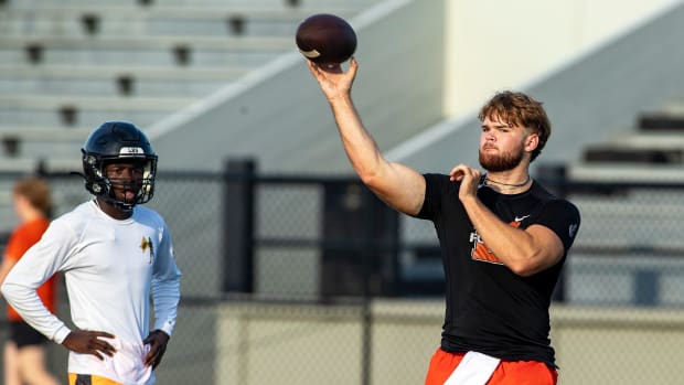 Lakeland High School quarterback Zander Smith throws a pass during their first day of practice at Bryant Stadium 