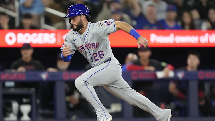 Sep 9, 2024; Toronto, Ontario, CAN; New York Mets pinch runner Eddy Alvarez (26) scores on a passed ball during the eighth inning against the Toronto Blue Jays at Rogers Centre. Mandatory Credit: John E. Sokolowski-Imagn Images