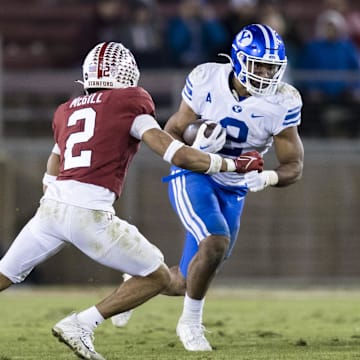 Nov 26, 2022; Stanford, California, USA;  Brigham Young Cougars running back Christopher Brooks (right) runs the ball against Stanford Cardinal safety Jonathan McGill (left) during the second half at Stanford Stadium.