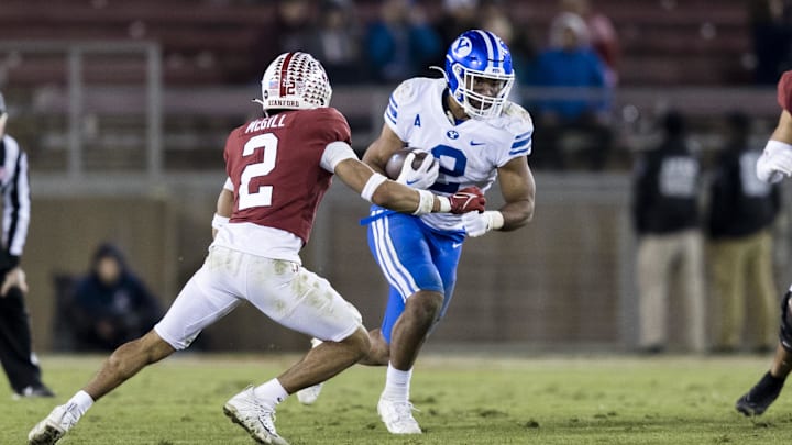 Nov 26, 2022; Stanford, California, USA;  Brigham Young Cougars running back Christopher Brooks (right) runs the ball against Stanford Cardinal safety Jonathan McGill (left) during the second half at Stanford Stadium.