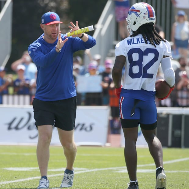 Joe Brady goes over routes with wide receiver Kristian Wilkerson