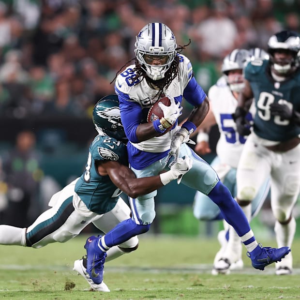 Philadelphia Eagles cornerback Jakorian Bennett tackles Dallas Cowboys wide receiver CeeDee Lamb.