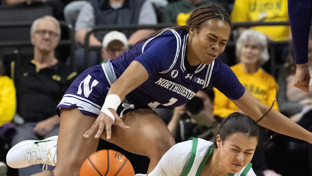 Oregon’s Ari Long, right, draws a player control foul against Northwestern’s Xamiya Walton during the first half at Matthew Knight Arena Jan. 1, 2026.