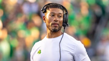 Oct 4, 2025; South Bend, Indiana, USA; Notre Dame head football coach Marcus Freeman adjusts his radio against the Boise State Broncos at Notre Dame Stadium. Mandatory Credit: Michael Caterina-Imagn Images