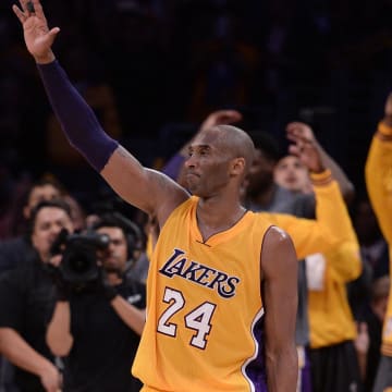 Apr 13, 2016; Los Angeles, CA, USA; Los Angeles Lakers forward Kobe Bryant (24) waves to the Staples Center crowd as he leaves the game against the Utah Jazz in the closing seconds. Bryant scored 60 points in the final game of his career. Mandatory Credit: Robert Hanashiro-USA TODAY Sports