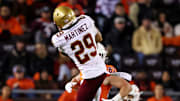 Oct 17, 2024; Blacksburg, Virginia, USA; Boston College Eagles defensive back Cameron Martinez (29) intercepts a pass by Virginia Tech Hokies quarterback Kyron Drones (1) during the third quarter at Lane Stadium. Mandatory Credit: Peter Casey-Imagn Images