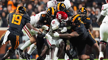 Oklahoma running back Tory Blaylock (6) is warmped by Tennessee linebacker Edwin Spillman (13), Tennessee linebacker Arion Carter (7) and Tennessee defensive lineman Daevin Hobbs (5) during a NCAA football game between the Tennessee Volunteers and Oklahoma Sooners at Neyland Stadium in Knoxville, Tenn., on November 1, 2025.