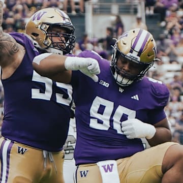 Jacob Bandes (55) and Elinneus Davis (90) celebrate Davis' first career sack. 