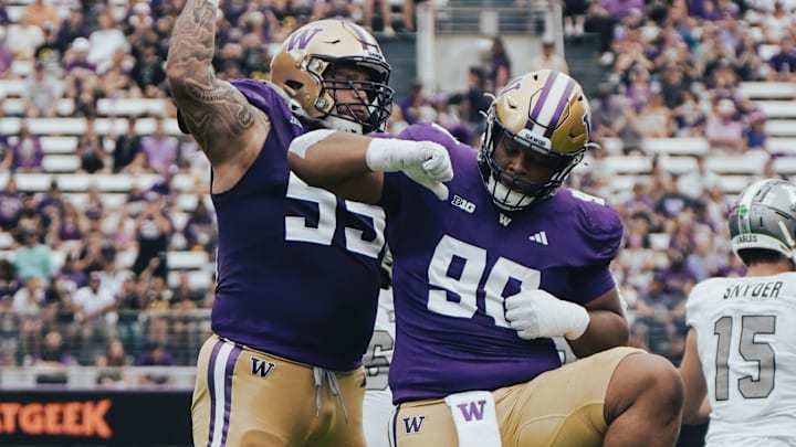 Jacob Bandes (55) and Elinneus Davis (90) celebrate Davis' first career sack. 