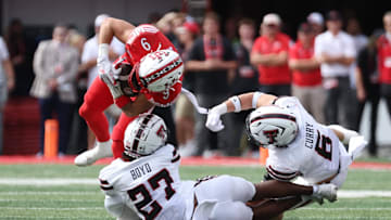 Sep 20, 2025; Salt Lake City, Utah, USA; Utah Utes wide receiver Ryan Davis (9) is tackled by Texas Tech Red Raiders defensive back Amier Boyd (27) and linebacker John Curry (6) during the first quarter at Rice-Eccles Stadium. Mandatory Credit: Rob Gray-Imagn Images