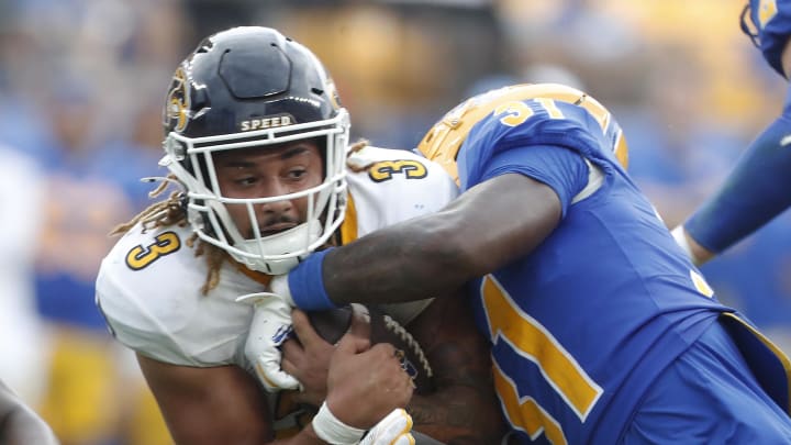 Aug 31, 2024; Pittsburgh, Pennsylvania, USA;  Kent State Golden Flashes running back Ky Thomas (3) runs the ball against Pittsburgh Panthers linebacker Rasheem Biles (31) during the third quarter at Acrisure Stadium. Pittsburgh won 55-24. Mandatory Credit: Charles LeClaire-USA TODAY Sports