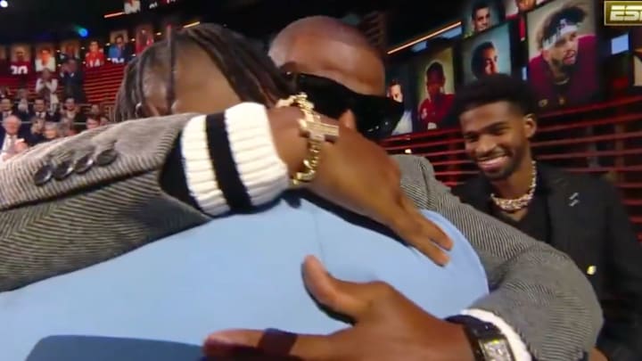 Deion Sanders and Travis Hunter embrace Deion Sanders and Travis Hunter embrace