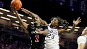 Dec 30, 2024; Manhattan, Kansas, USA; Cincinnati Bearcats guard Jizzle James (2) shoots against Kansas State Wildcats guard Macaleab Rich (23) during the first half at Bramlage Coliseum. Mandatory Credit: Jay Biggerstaff-Imagn Images