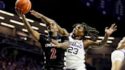 Dec 30, 2024; Manhattan, Kansas, USA; Cincinnati Bearcats guard Jizzle James (2) shoots against Kansas State Wildcats guard Macaleab Rich (23) during the first half at Bramlage Coliseum. Mandatory Credit: Jay Biggerstaff-Imagn Images