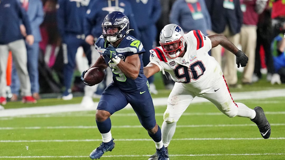 Feb 8, 2026; Santa Clara, CA, USA; Seattle Seahawks running back Kenneth Walker III (9) runs the ball as New England Patriots defensive tackle Christian Barmore (90) defends during the third quarter in Super Bowl LX at Levi's Stadium. Mandatory Credit: Cary Edmondson-Imagn Images