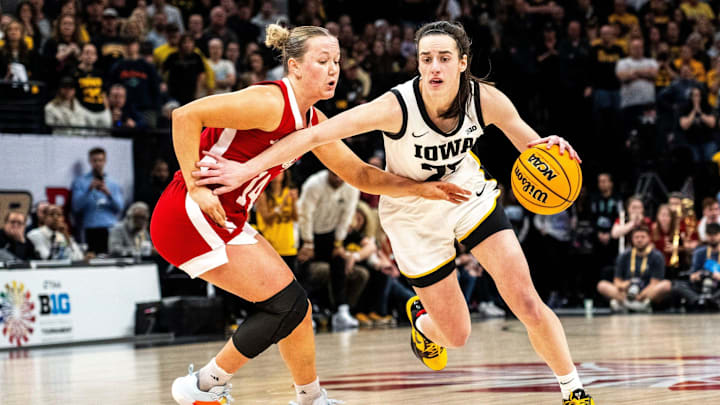 Iowa guard Caitlin Clark (22) drives to the basket against Nebraska guard Callin Hake during the Big Ten Tournament championship game at the Target Center on Sunday, March 10, 2024, in Minneapolis, Minn. Iowa guard Caitlin Clark (22) drives to the basket against Nebraska guard Callin Hake during the Big Ten Tournament championship game at the Target Center on Sunday, March 10, 2024, in Minneapolis, Minn.
