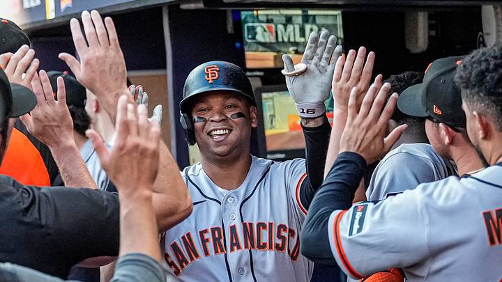 Cumberland, Georgia, USA; San Francisco Giants designated hitter Rafael Devers (16) reacts in the dugout after hitting a home run against the Atlanta Braves during the first inning at Truist Park. Mandatory Credit: Dale Zanine-Imagn Images