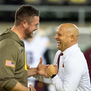 Oregon head coach Dan Lanning, left, and Minnesota head coach P. J. Fleck interact before the game as the Oregon Ducks host the Minnesota Golden Gophers on Nov. 14, 2025, at Autzen Stadium in Eugene, Oregon.