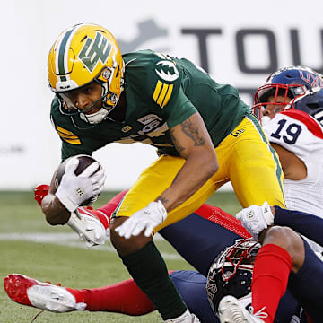 Jun 14, 2024; Edmonton, Alberta, CAN; Edmonton Elks wide receiver Eugene Lewis (87) catches the ball in front of Montreal Alouettes linebacker Geoffrey Cantin-Arku (19) during the second half at Commonwealth Stadium. Mandatory Credit: Perry Nelson-Imagn Images