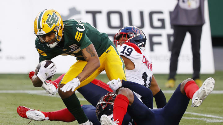 Jun 14, 2024; Edmonton, Alberta, CAN; Edmonton Elks wide receiver Eugene Lewis (87) catches the ball in front of Montreal Alouettes linebacker Geoffrey Cantin-Arku (19) during the second half at Commonwealth Stadium. Mandatory Credit: Perry Nelson-USA TODAY Sports