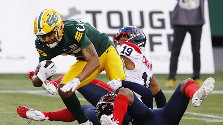 Jun 14, 2024; Edmonton, Alberta, CAN; Edmonton Elks wide receiver Eugene Lewis (87) catches the ball in front of Montreal Alouettes linebacker Geoffrey Cantin-Arku (19) during the second half at Commonwealth Stadium. Mandatory Credit: Perry Nelson-Imagn Images